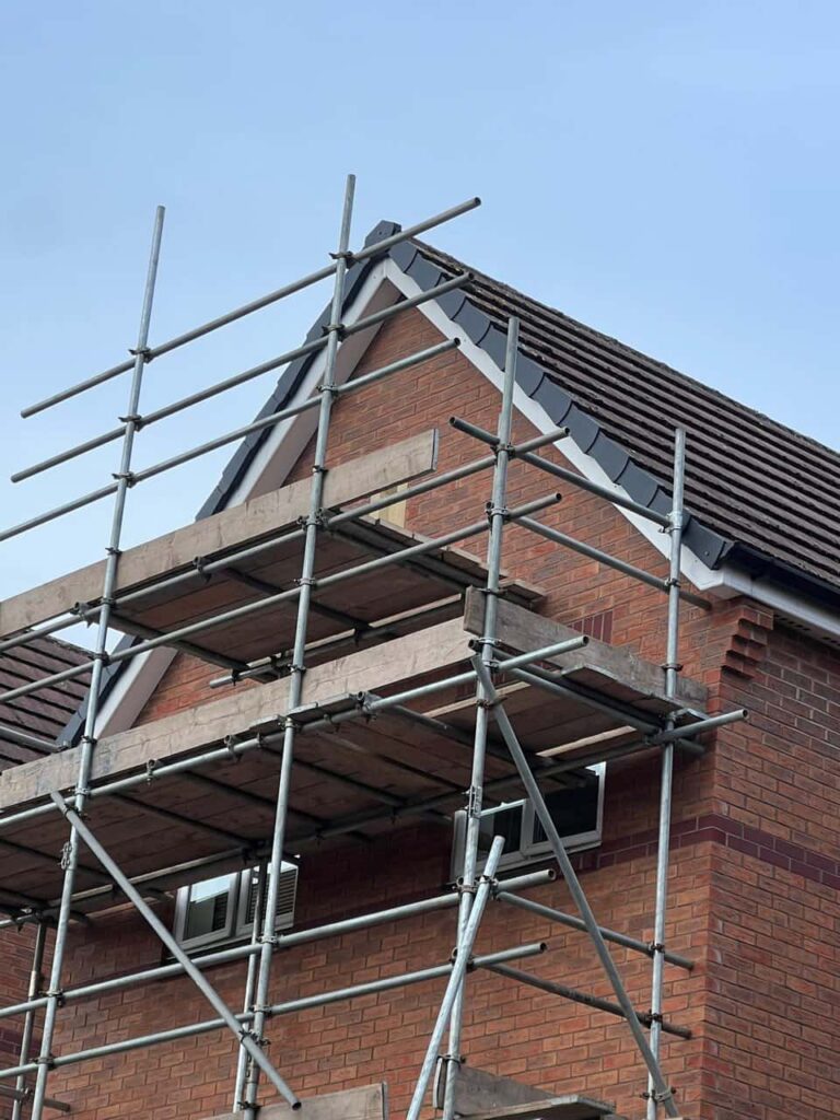 This is a photo of a roof which has just been repaired. There is a scaffold located at the gable end for access onto the roof. Works carried out by Newmarket Roofing Repairs